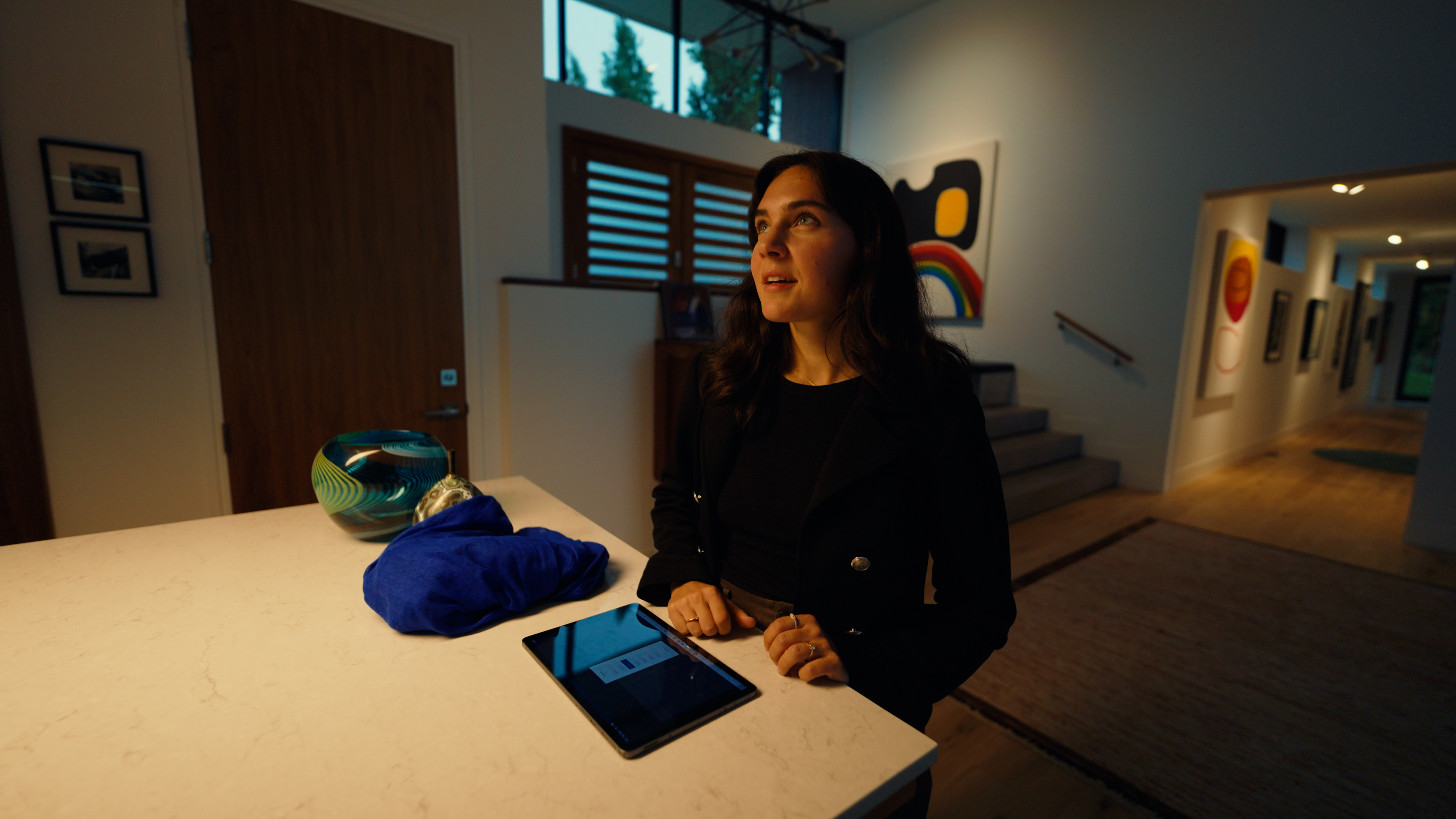 Woman stands in kitchen with smart lighting